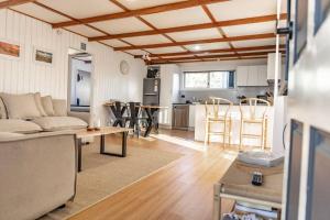 a living room with a couch and a table at Bay Breeze - Boat - Bike - Hike in St Helens +25 photos