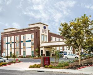 a hotel building with a sign in front of it at Comfort Suites Woodland - Sacramento Airport in Woodland