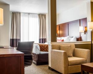 a hotel room with a bed and a chair and a desk at Comfort Suites Woodland - Sacramento Airport in Woodland