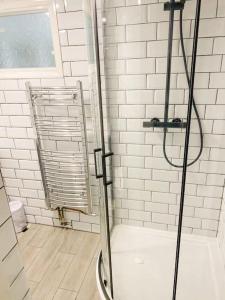 a shower with a glass door in a bathroom at Gravesend - 1 bedroom Apartment in Kent