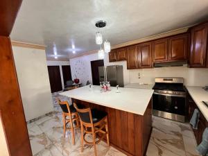 a kitchen with a island in the middle of it at Casa Amplia con Piscina in San Felipe de Puerto Plata