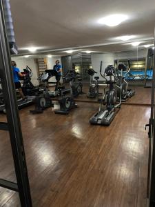 a gym with several treadmills and exercise bikes at Amoblados MyK Metro Irarrazabal in Santiago