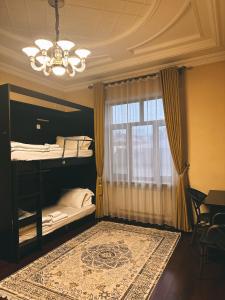 a bedroom with a bunk bed and a window at CITY GARDEN HOTEL in Dushanbe