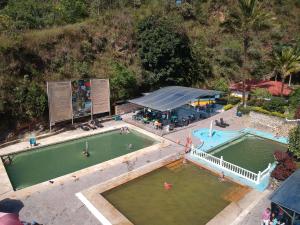 einen Blick über zwei Swimmingpools und ein Gebäude in der Unterkunft Centro Vacacional Paraiso Termal in Tibirita