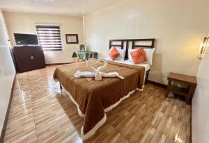 una habitación de hotel con una cama con un animal de peluche. en Elegance Guesthouse en Manila
