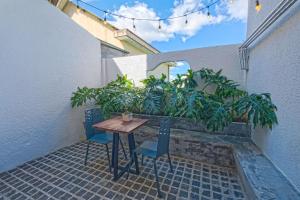 a table and chairs on a patio with plants at Mayy House Dalat in Da Lat