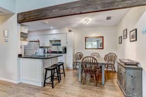 a kitchen and dining room with a table and chairs at Amelia Island Paradise Rental! in Fernandina Beach