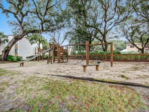 a playground with a slide in a park at Amelia Island Paradise Rental! in Fernandina Beach
