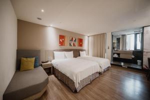 Postel nebo postele na pokoji v ubytování Hub Hotel Kaohsiung Yawan Branch