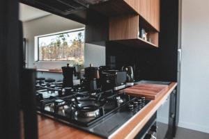 a kitchen with a stove top oven in a kitchen at Carlton River Escape in Carlton
