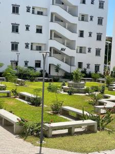 a large white building with benches in front of it at Cindy's Ample home in Mombasa