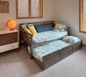 A quiet, stylish and cozy retreat. في بيج: غرفة نوم بسريرين توأم وطاولة بجانب السرير
