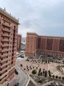 a view of two large buildings and a courtyard at ЖК Green Plaza in Aktau