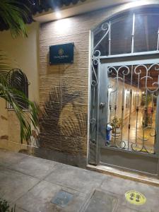 a gate to a building with a sign on it at Hotel Via Morburg in Nazca