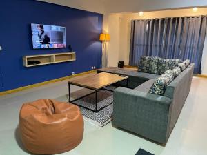 a living room with a couch and a coffee table at Backpackers Hostel Islamabad in Islamabad