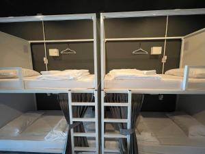 a room with three bunk beds in it at Sleep4cheap@Donsak in Don Sak
