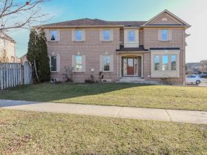 a large brick house with a fence in a yard at Elegant 5BDR in Mississauga, Brampton, Toronto in Mississauga