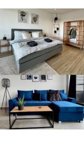 sala de estar con cama y sofá azul en PISO SUPERIOR - Exklusives Apartment an der Promenade mit Rheinsicht & Loggia en Emmerich