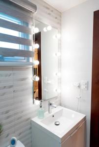a bathroom with a sink and a mirror at Amazing Rooftop and Best View of the City in Santiago de los Caballeros