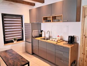 a kitchen with stainless steel appliances and a window at Chwila Moment - apartament lub cały dom w górach in Stronie Śląskie