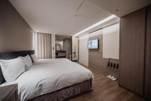Postel nebo postele na pokoji v ubytování Hub Hotel Kaohsiung Yawan Branch