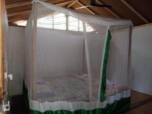 a bed in a room with a canopy at Ruban Yoga Palolem in Palolem