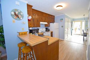 a kitchen with wooden cabinets and a counter top at Sea Jay Townhouse 616C in Ocean City