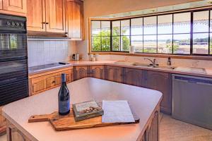 SandfordPrestigious Expansive Home with Almost Everything的厨房在柜台上备有一瓶葡萄酒