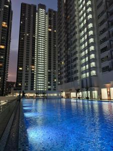 a large swimming pool in a city with tall buildings at HH KL Prime location Residence near TRX in Kuala Lumpur