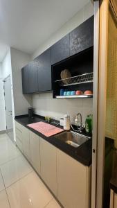 a kitchen with a sink and a microwave at HH KL Prime location Residence near TRX in Kuala Lumpur