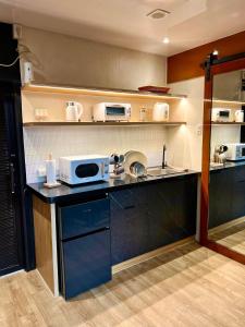 a kitchen with a counter with a microwave on it at Cozy Tiny Home with Outdoor Hot Tub in City Center in Davao City