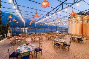 a restaurant with tables and chairs and lights at The Neeraj Ganga Heritage Palace in Rishīkesh