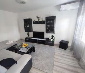 a living room with a couch and a table at Old House Lapis- pool, hot tub, BBQ in Zadvarje