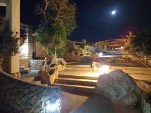 a garden at night with a bunch of rocks at Residence Punta Sottile A 2 passi dalla spiaggia di cala francese Lampedusa in Lampedusa