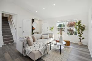 a white living room with a couch and a table at Tranquil Pet Friendly Retreat residence in Reynoldsburg