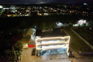 a white building with lights on it at night at Caishen Modern Affordable Apartelle 302 in Silang