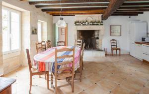 cocina y comedor con mesa y chimenea en La Fleur Godard, en Lussac