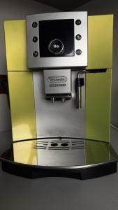 a coffee machine with a microwave on top of it at Mucenieku Apartamenti in Kuldīga