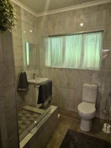 a bathroom with a toilet and a sink at Air Lakehouse in Hilton