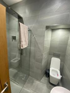 a bathroom with a shower and a toilet and a sink at Newly refurbished apartment in Chapel Allerton, Leeds in Moortown