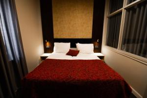 a hotel room with a bed with a red blanket at Lev Yerushalayim Hotel in Jerusalem