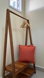 a wooden bench with a red pillow in a room at Casa Leonardo in Bacungan