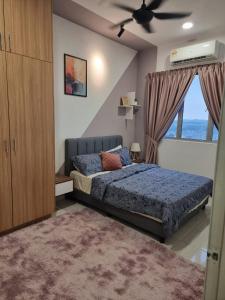 a bedroom with a bed and a large window at ZIYAD AL KHAYR HOMESTAY in Kajang