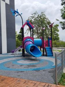 a playground with a slide in a park at ZIYAD AL KHAYR HOMESTAY in Kajang