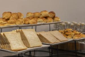 a display of bread and pastries on trays at The Wander by Sarai in Siem Reap