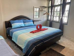 Postel nebo postele na pokoji v ubytování Sawasdee hatyai City House