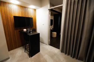 a hotel room with a desk and a television in a room at Lev Yerushalayim Hotel in Jerusalem