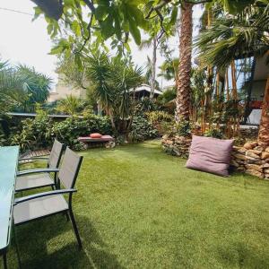 a garden with two chairs and a pillow on the grass at Le Zen in La Ciotat