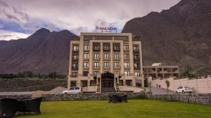 un gran edificio con un cartel encima en Ramada Hotel Gilgit en Gilgit