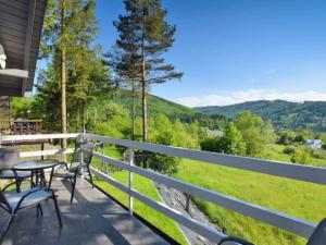 a balcony with chairs and a table and a view at DOMeK NINA in Brenna